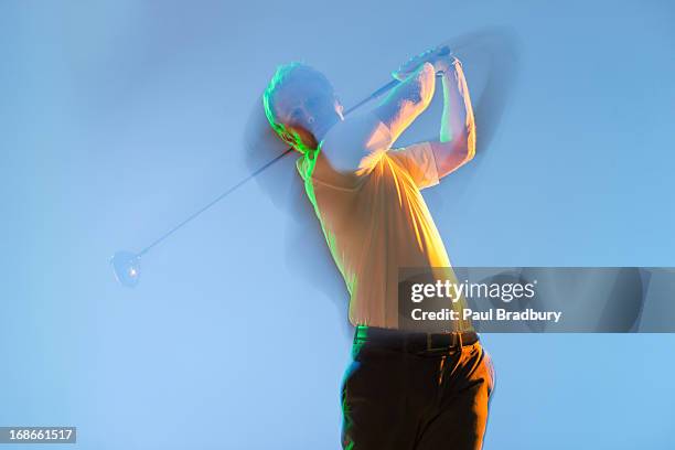 blurred view of golf player swinging club - practising stock pictures, royalty-free photos & images