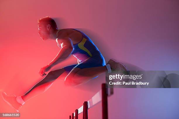 blurred view of athlete jumping hurdles - häcklöpning löpgren bildbanksfoton och bilder