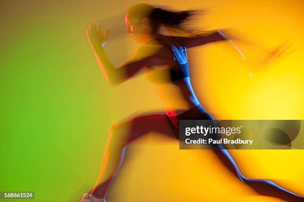 blurred view of athlete running - track starting block stock pictures, royalty-free photos & images