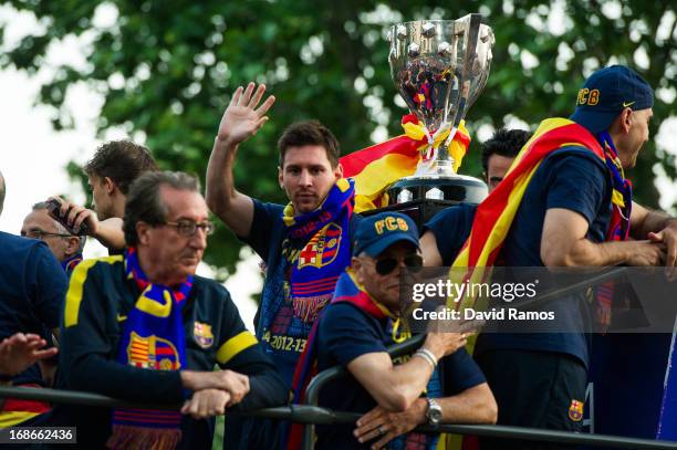 Lionel Messi of FC Barcelona celebrates with team-mates on an open top bus during their victory parade after winning the Spanish Liga title on May...