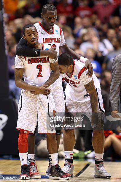Russ Smith, Gorgui Dieng and Chane Behanan of the Louisville Cardinals react after Kevin Ware suffered a compound fracture to his leg in the first...