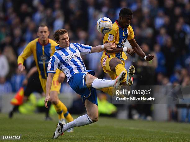 Dean Hammond of Brighton challenges Wilfried Zaha of Crystal Palace during the npower Championship Play Off Semi Final Second Leg between Brighton &...