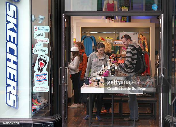 Customers shop for shoes at a Skechers store on May 13, 2013 in San Francisco, California. According to a Commerce Department report, falling gas...