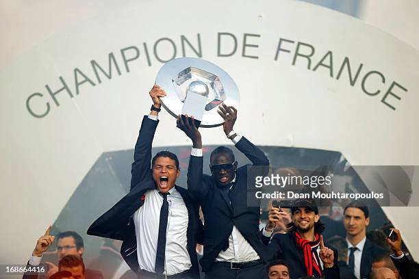 Captain, Thiago Silva and Mamadou Sakho of PSG celebrate in front of the fans after winning Ligue 1 during the Paris Saint-Germain Trophy Ceremony at...