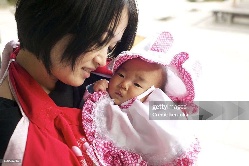 A mother hugs her baby