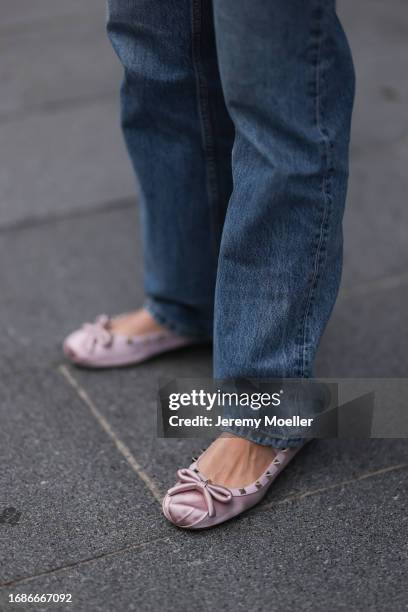 Fashion Show Guest was seen wearing blue denim jeans and shiny rose Valentino Ballerinas before the Huishan Zhang Fashion Show during London Fashion...