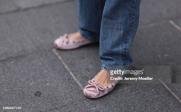 Fashion Show Guest was seen wearing blue denim jeans and shiny rose Valentino Ballerinas before the Huishan Zhang Fashion Show during London Fashion...