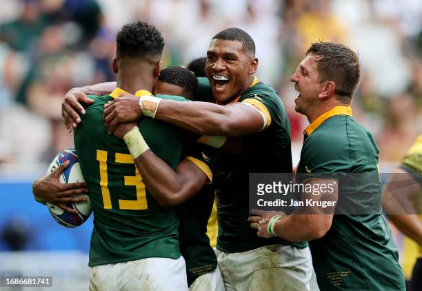 Grant Williams of South Africa celebrates with Canan Moodie, Damian Willemse and Kwagga Smith of South Africa after scoring his team's seventh try...