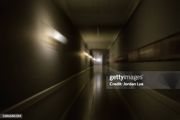 blur motion of dark creepy corridor - fantasma fotografías e imágenes de stock