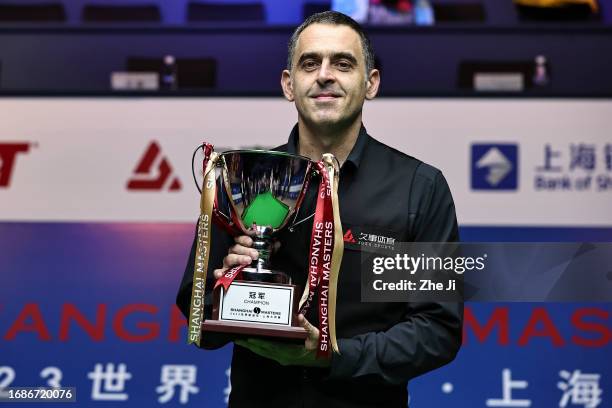 Ronnie O'Sullivan of England holds the trophy after winning the final match against Luca Brecel of Belgium on Day 7 of World Snooker Shanghai Masters...