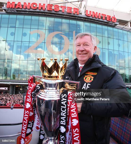 Manager Sir Alex Ferguson of Manchester United poses with the Premier League trophy at the start of the Premier League trophy winners parade on May...