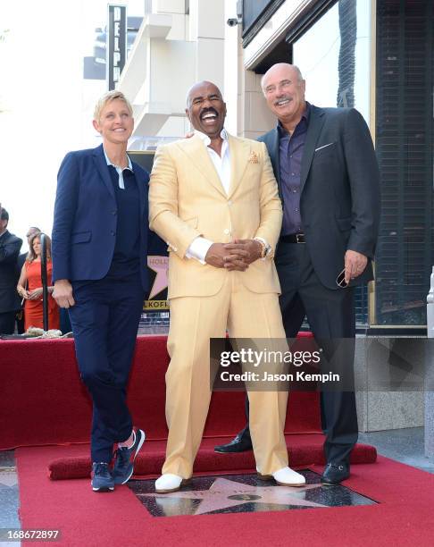 Actor and radio host Steve Harvey poses on his star on the Hollywood Walk of Fame with television personalities Ellen DeGeneres and Dr Phil McGraw at...