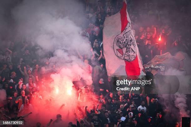 Ajax supporters set off fireworks during the Dutch Eredivisie match between Ajax and Feyenoord at the Johan Cruijff ArenA on September 24, 2023 in...