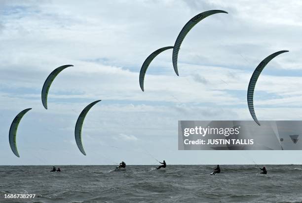Competitors race during the final day of the 2023 Formula Kite European Championships, in Portsmouth, southern England, on September 24, 2023.