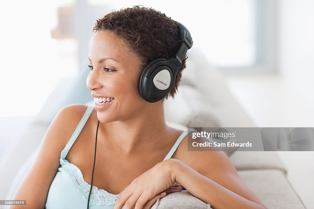 Woman sitting on couch and  Listning music
