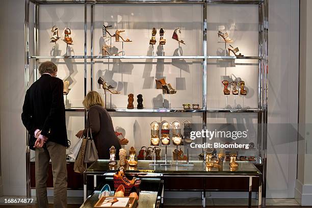 Customers browse shoes at a Coach Inc. Store in New York, U.S., on Monday, May 13, 2013. Sales at U.S. Retailers unexpectedly advanced in April,...