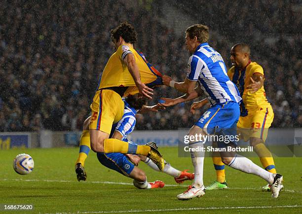 Mile Jedinak of Crystal Palace is held back by Dean Hammond of Brighton & Hove Albion during the npower Championship play off semi final second leg...