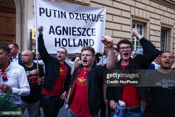 Banner reading 'Putin thanks Agnieszka Holland' is seen while far-right activists demonstrate against Agnieszka Holland's movie 'The Green Border' in...