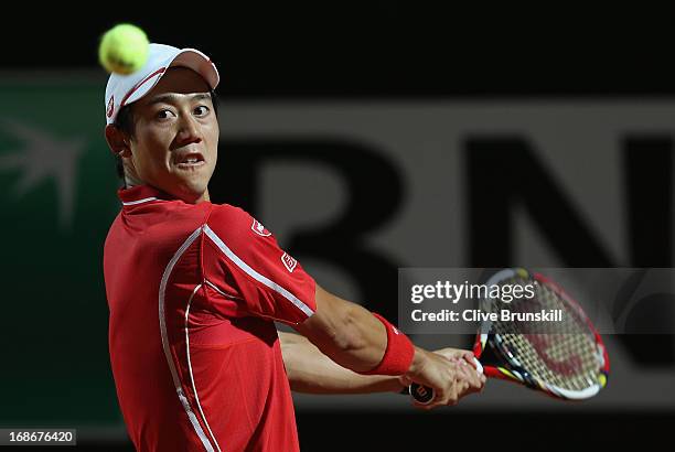 Kei Nishikori of Japan plays a backhand against Paolo Lorenzi of Italy in their first round match during day two of the Internazionali BNL d'Italia...