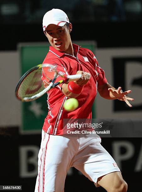 Kei Nishikori of Japan plays a forehand against Paolo Lorenzi of Italy in their first round match during day two of the Internazionali BNL d'Italia...