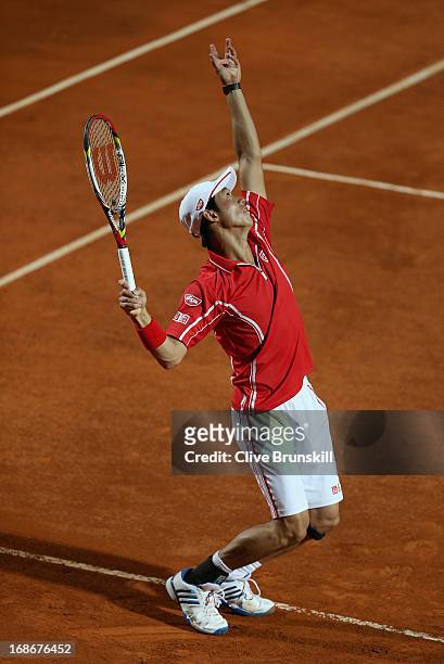 Kei Nishikori of Japan serves against Paolo Lorenzi of Italy in their first round match during day two of the Internazionali BNL d'Italia 2013 at the...