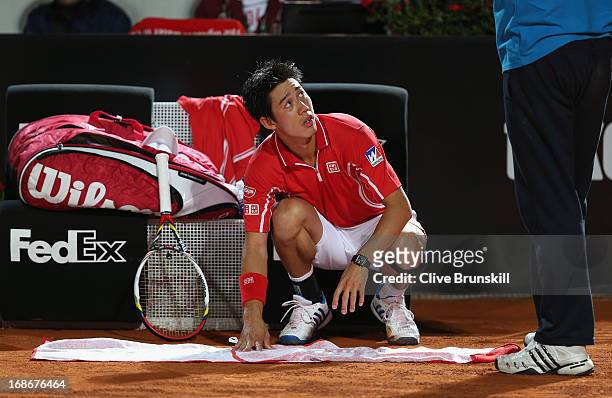 Kei Nishikori of Japan about to receive treatment in a medical timeout against Paolo Lorenzi of Italy in their first round match during day two of...