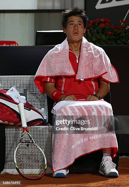 Kei Nishikori of Japan relaxes during a change of ends against Paolo Lorenzi of Italy in their first round match during day two of the Internazionali...