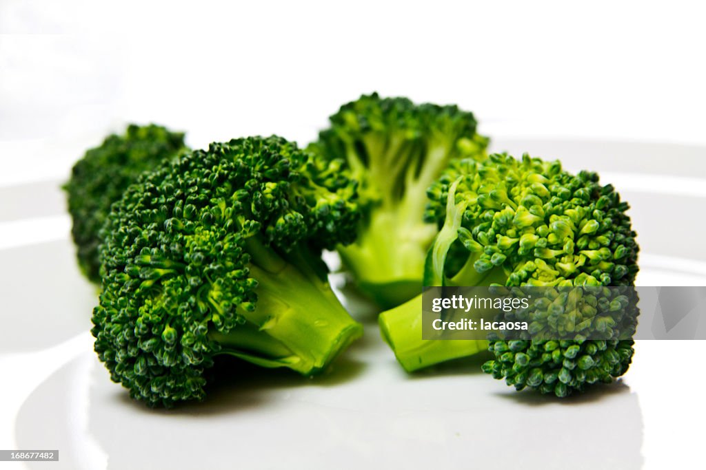 Fresh brokkoli florets on white plate