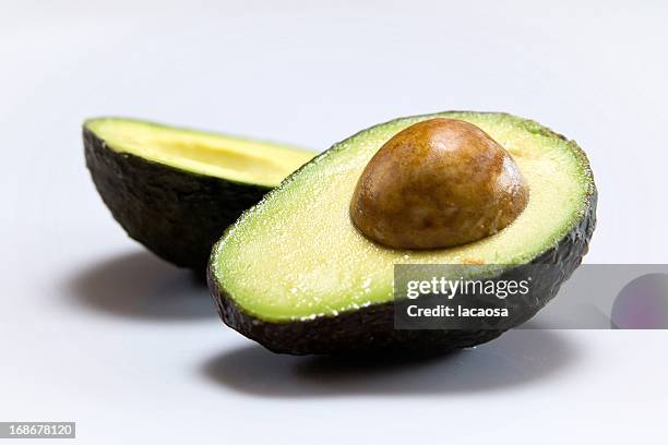 fresh sliced avocado - high density lipoprotein stock pictures, royalty-free photos & images