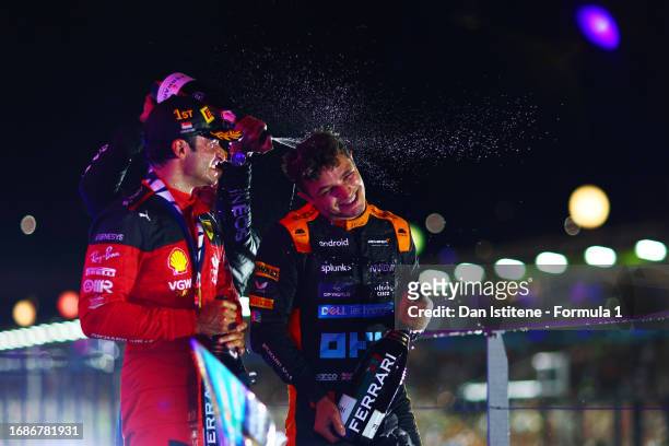 Race winner Carlos Sainz of Spain and Ferrari celebrates with Second placed Lando Norris of Great Britain and McLaren and third placed Lewis Hamilton...