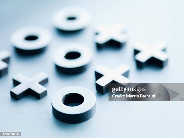 metal tic-tac-toe game pieces - strategy game stock pictures, royalty-free photos & images