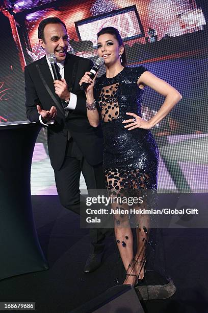 Nikos Aliagas and Eva Longoria perform on stage during the 'Global Gift Gala' at Hotel George V on May 13, 2013 in Paris, France.