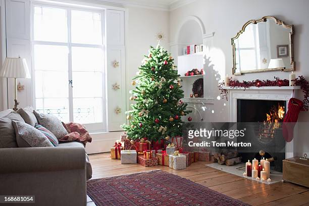 christmas tree surrounded with gifts - christmas window stock pictures, royalty-free photos & images
