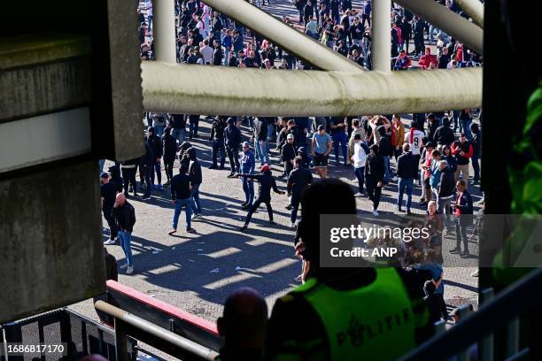 Police use tear gas after the Dutch Eredivisie match between Ajax and Feyenoord in the Johan Cruijff ArenA on September 24, 2023 in Amsterdam, the...