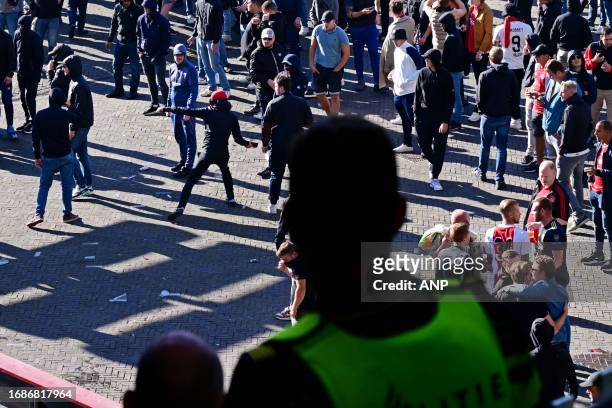 Police use tear gas after the Dutch Eredivisie match between Ajax and Feyenoord in the Johan Cruijff ArenA on September 24, 2023 in Amsterdam, the...