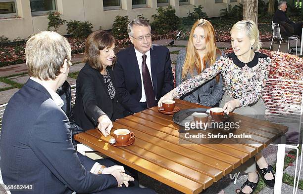 Treasurer Wayne Swan and his family enjoy a coffee during a photo opportunity on May 14, 2013 in Canberra, Australia. Treasurer Wayne Swan will...