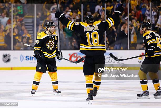 Patrice Bergeron of the Boston Bruins celebrates after scoring the game-tying goal in the third period against the Toronto Maple Leafs in Game Seven...