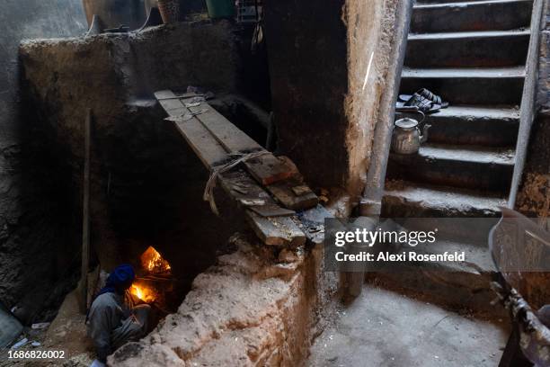 Muhammad Sudani from Marrakech, tends to the hamam spa fire by throwing wood chips, and anything flammable into the furness at the souk on September...