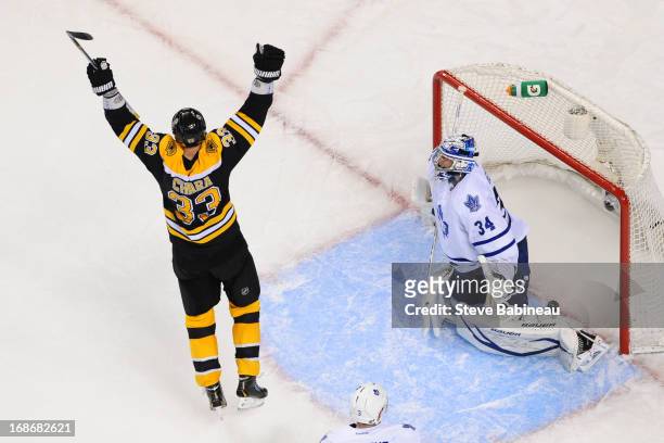Zdeno Chara of the Boston Bruins throws his arms up after a goal against James Reimer of the Toronto Maple Leafs in Game Seven of the Eastern...
