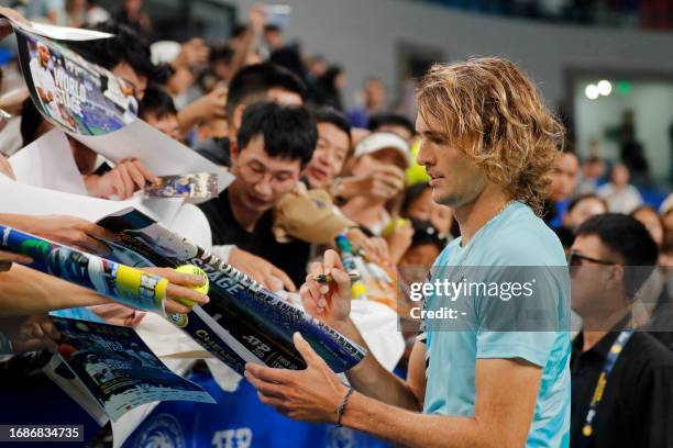 Alexander Zverev of Germany signs autographs for fans after his win against Miomir Kecmanovic of Serbia in the men's singles quarter-final match at...