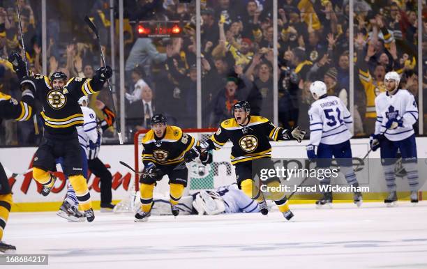 Patrice Bergeron and Tyler Seguin of the Boston Bruins celebrate following Bergeron's game-winning overtime goal against the Toronto Maple Leafs in...