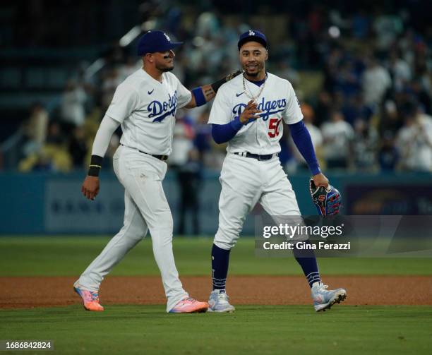 Los Angeles Dodgers shortstop Miguel Rojas and Los Angeles Dodgers second baseman Mookie Betts walk off the field together after the Dodgers 7-0 win...