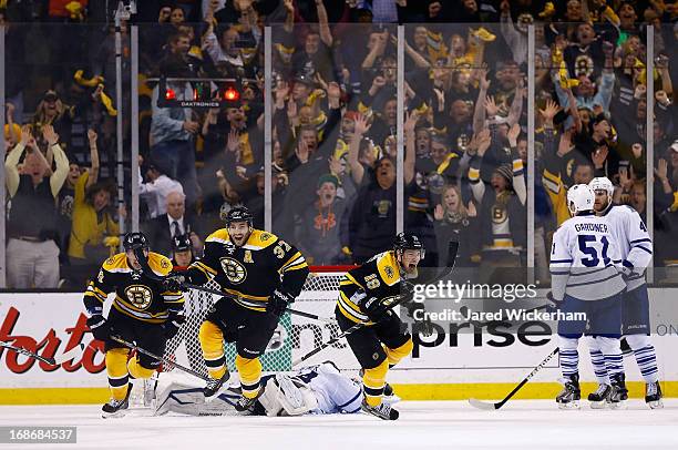 Patrice Bergeron, Tyler Seguin, and Brad Marchand of the Boston Bruins celebrate following Bergeron's game-winning overtime goal against the Toronto...