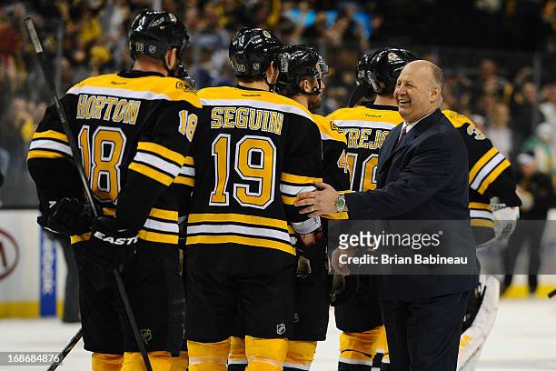 Head Coach Claude Julien of the Boston Bruins smiles with his team after the overtime win against the Toronto Maple Leafs in Game Seven of the...