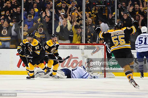 Patrice Bergeron of the Boston Bruins scores a goal in overtime to win the game against the Toronto Maple Leafs in Game Seven of the Eastern...