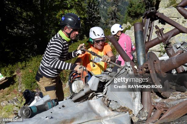 Volunteers take part in a clean-up operation for remaining debris of the DC3 plane that crashed on October 7 causing the death of 34, in the Canigou...