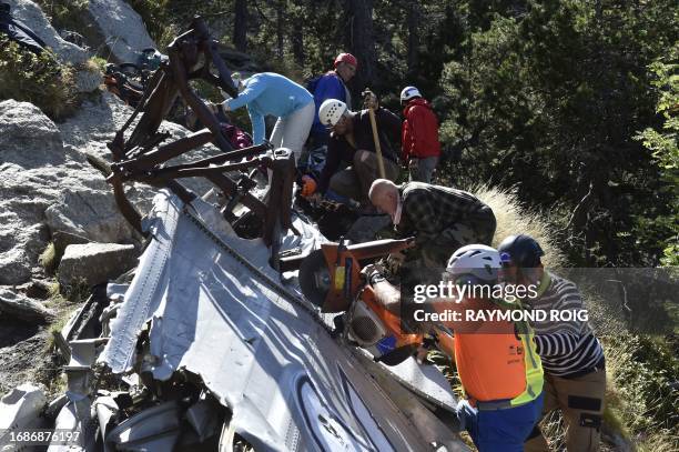 Volunteers take part in a clean-up operation for remaining debris of the DC3 plane that crashed on October 7 causing the death of 34, in the Canigou...