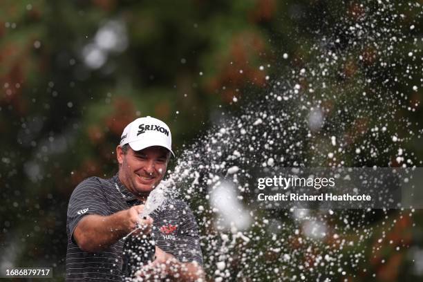 Ryan Fox of New Zealand sprays champagne in celebration after securing victory on Day Four of the BMW PGA Championship at Wentworth Golf Club on...