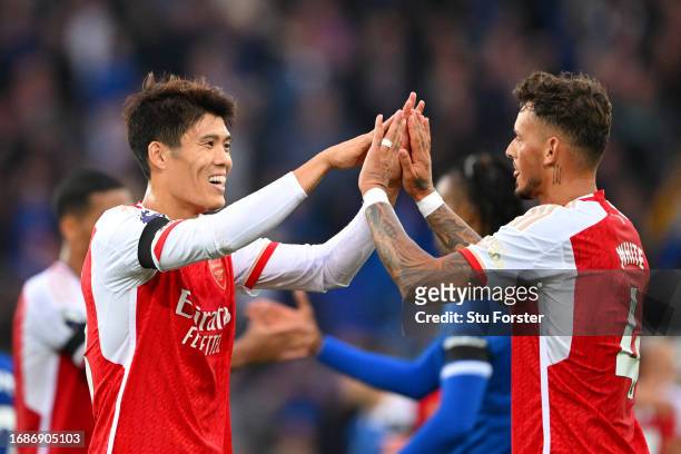 Takehiro Tomiyasu and Ben White of Arsenal celebrate after the team's victory in the Premier League match between Everton FC and Arsenal FC at...