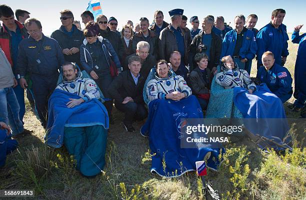 In this handout image provided by NASA, Expedition 35 Commander Chris Hadfield of the Canadian Space Agency , left, Russian Flight Engineer Roman...